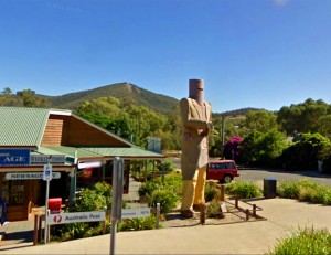 A giant statue of Ned Kelly towers over shops in Glenrowan