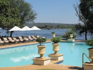 The pool at the Royal Livingstone, with the spray of Vic Falls in the background.