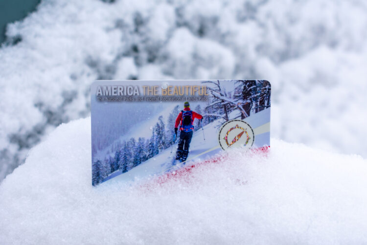 America the Beautiful Pass National Parks and Federal Recreational Lands annual pass card in the fresh winter snow