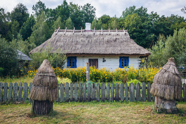 Beehives in front of traditional wooden cottage in Budy, small village located in Bialowieza Forest