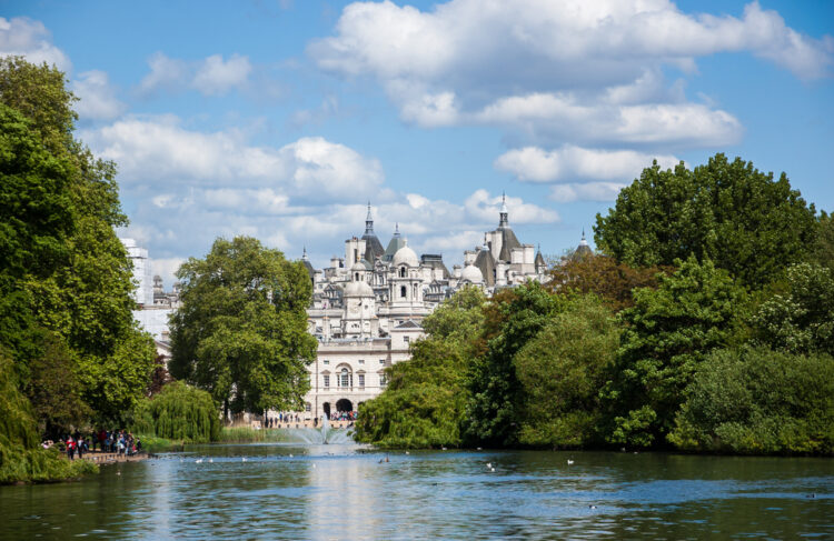 A cityscape view through the Serpentine lake in Hyde Park