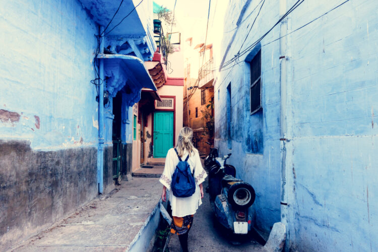 Female traveler walks down narrow streets