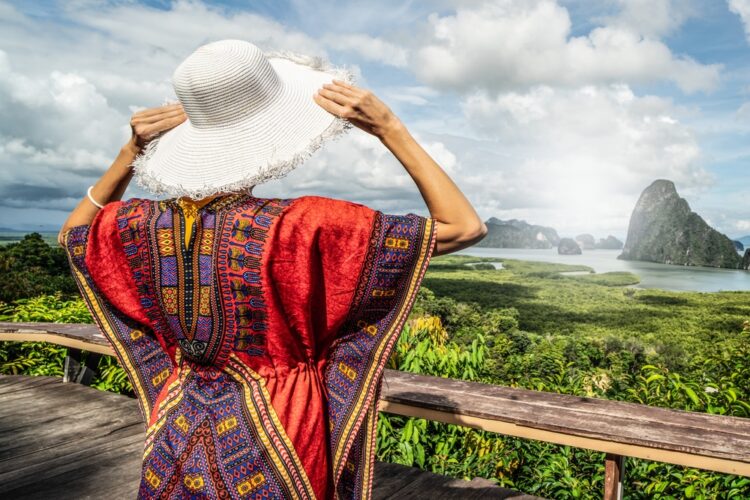 Female traveler looks over a valley