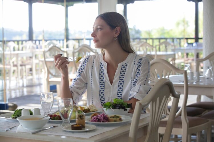 Female solo traveler eating alone