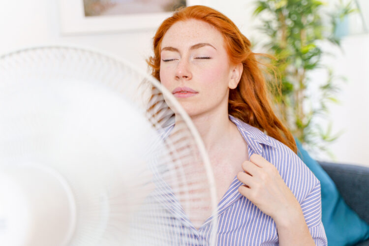 Woman cooling in front of fan