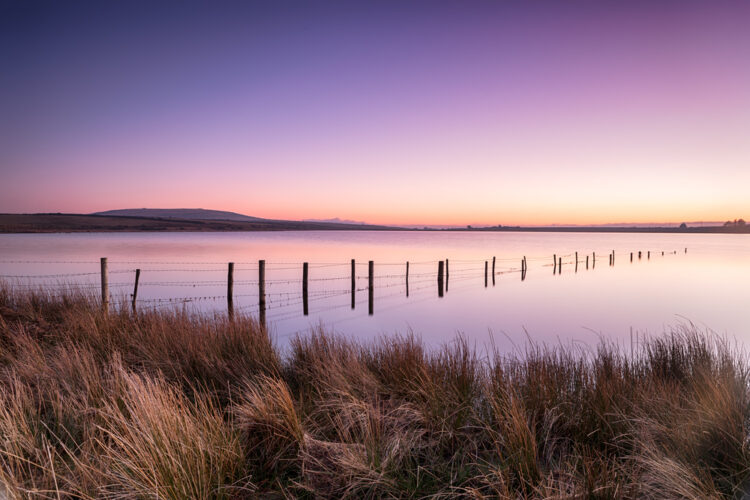 Vibrant dusk over Dozmary Pool a small natural lake on Bodmin Moor in Cornwall