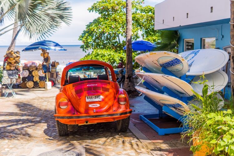 Classic red VW Beetle and surfboards in the magic town of Sayulita