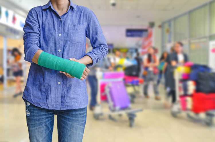 A woman walks through a hospital with a broken arm