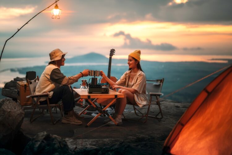 Man and woman relaxing outside their tent