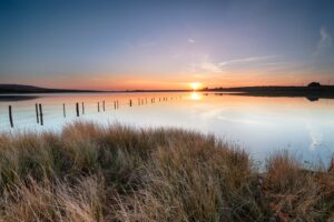 Winter sunset over Dozmary Pool on Bodmin Moor in Cornwall