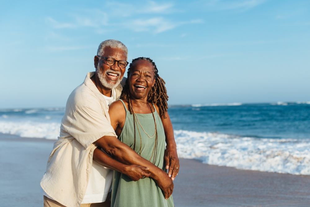 Older african american couple at the beach having fun