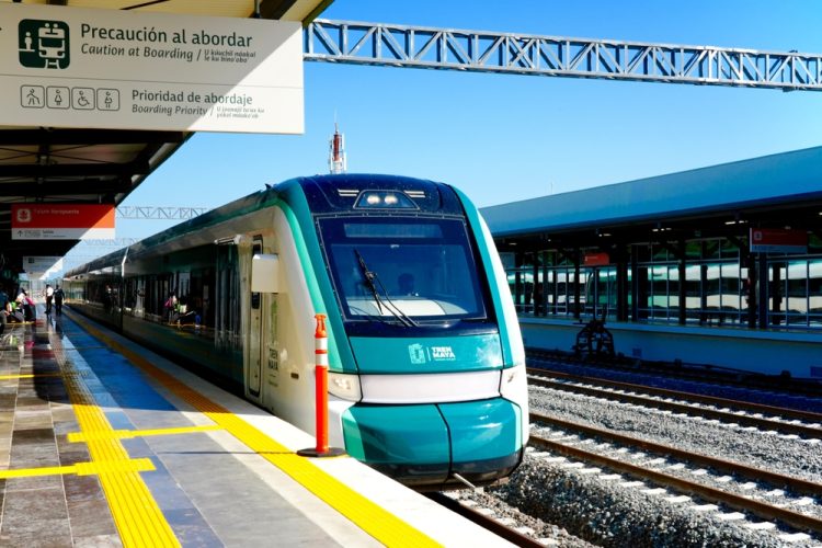 Tren Maya's sleek new train cars pull into the Tulum Airport Station where travelers can connect with international flights.