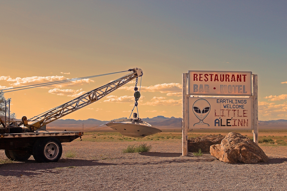 Truck hauling away a model of a UFO