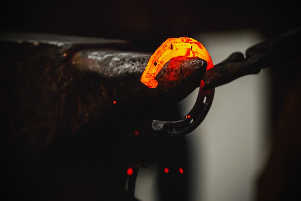 Blacksmith shaping a horseshoe